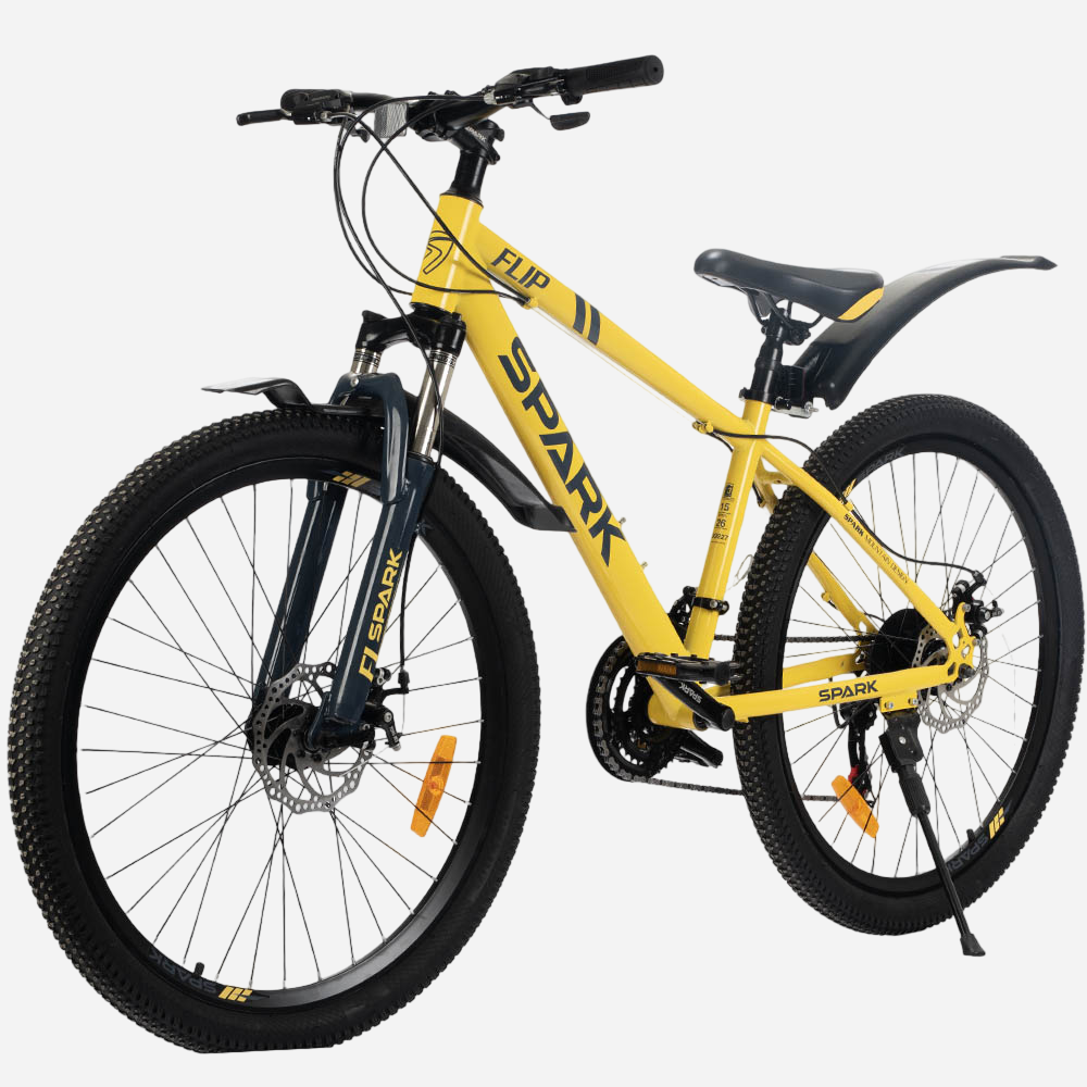 Гірський велосипед Spark FLIP 26" жовтий, вид спереду під кутом — амортизаційна вилка Spark з крилом, дискові гальма, руль з манетками Shimano, широкі покришки 26×2.35